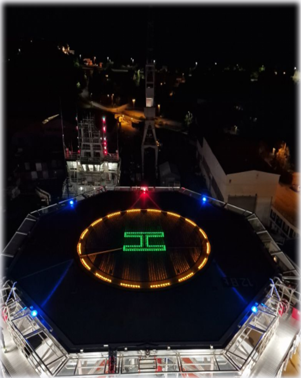 A large circular light illuminates the helideck of a FPSO at night, showcasing all required lights in operation.

The helideck of a FPSO is brightly lit at night, featuring a prominent circular light atop the FPSO.